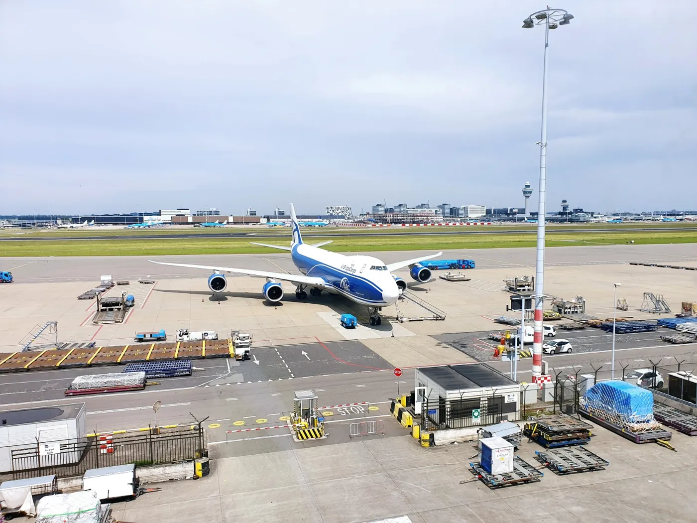 A freighter on the cargo apron at Amsterdam Schiphol, the control tower behind it.